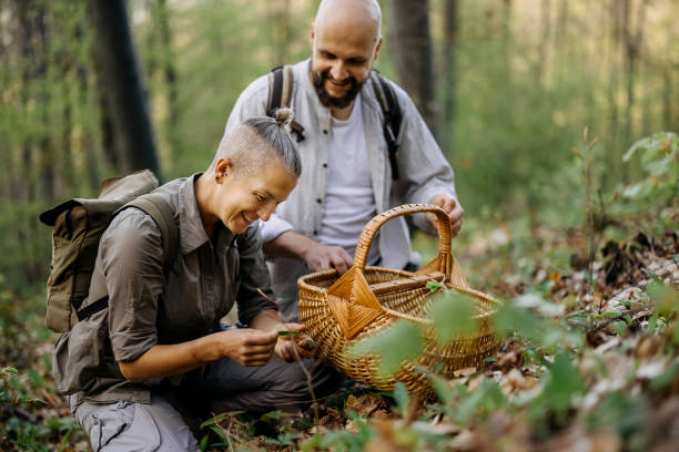 istock People who go hiking pick plants 2148791908