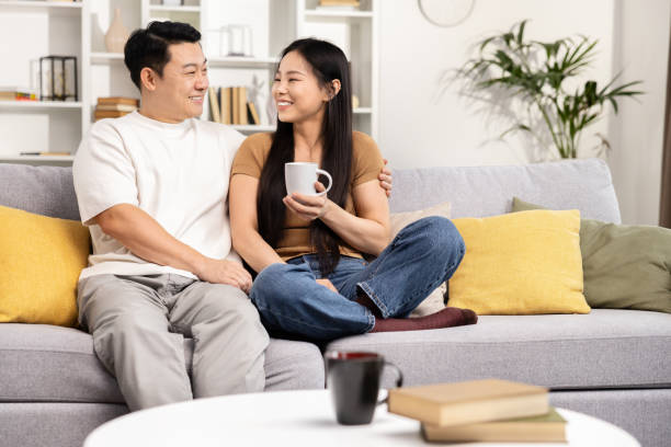 istock Loving Couple Relaxing Together at Home on Sofa 2148791930