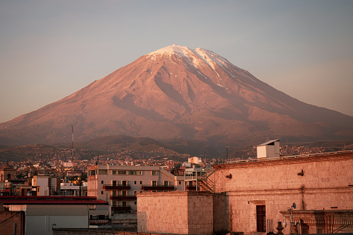 Experience the captivating beauty of Peru's picturesque city of Arequipa with this stunning stock photo capture. Behold the mesmerising sunset casting its golden glow over the iconic Chachani Volcano, creating a breathtaking Andean landscape that will leave you in awe. Immerse yourself in the rich colors and dramatic scenery of this South American gem, perfect for travel brochures, website backgrounds, or any project needing a touch of natural splendour. Download now and let the enchantment of Arequipa's skyline enhance your creative endeavours.