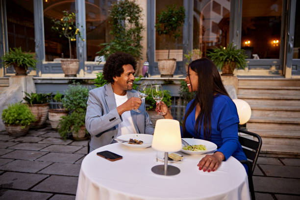 Celebratory toast during restaurant dinner date