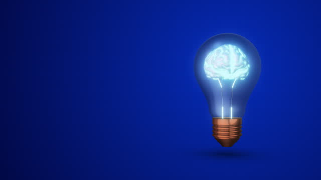 Glowing human brain in a lightbulb on a blue background