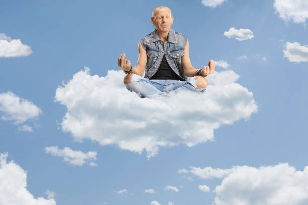istock Bald man sitting corssed legged on a cloud 2148794094