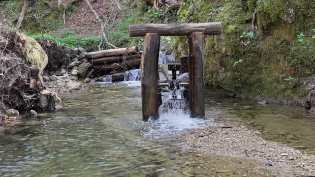 SLO MO Small wooden mill wheel rotates under water pressure
