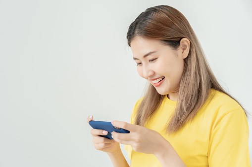 excited young woman play games by mobile phone make winner gesture. female winning mobile gambling. Wow face expression. Esport streaming game online, surprise, gamer, online, earning, new generation