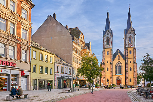 Hof, Germany - September 19, 2023: pedestrians in the old town of Hof. In the background is St. Mary's Church on Lorenzstrasse.