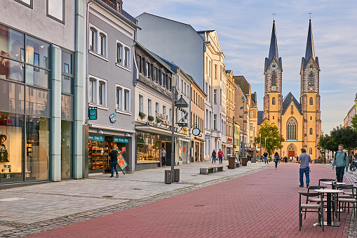 Hof, Germany - September 19, 2023: pedestrians in the old town of Hof. In the background is St. Mary's Church on Lorenzstrasse.