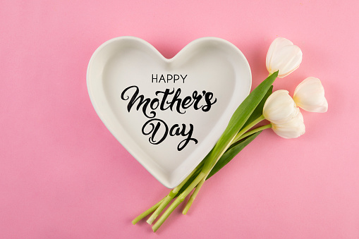 Mother’s Day and concept with tulips and heart shaped bowl