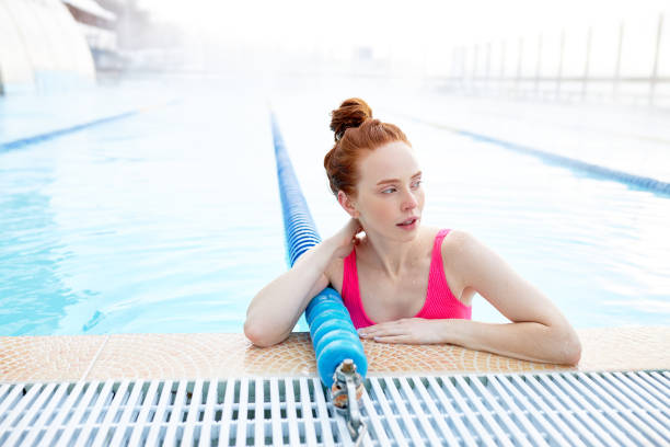 istock tired good-looking ginger swimmer looking aside 2148797705