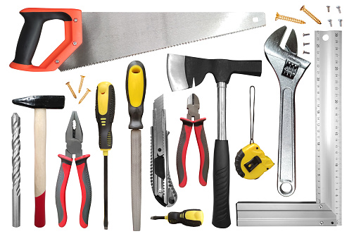 Assortment of various tools and workplace supplies, arranged neatly on a white backdrop. DIY Handy equipment toolbox essentials.