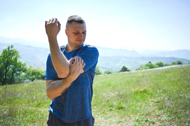 istock Young man stretching arms in public park in. a sunny day. 2148798023