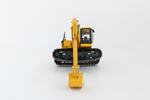 Yellow excavator  on  a white background,With  using a bucket to lift the crawler up