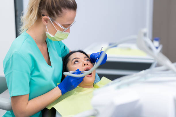 istock Woman having her teeth checked during dental appointment at dentist's office 2148798763