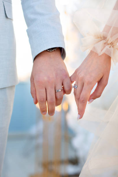 Bride Groom Hand Detail Close-up photo of the men`s holding woman hand with golden wedding ring with diamond. Wedding ring before the proposal. Luxury wedding rings hands of bride and bridegroom in wedding marriage ceremony stock pictures, royalty-free photos & images