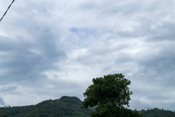 Green mountain scenery with dark clouds in the background