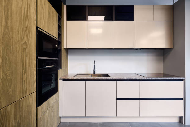 istock Urban rustic loft style kitchen interior in wooden facade and stoneware countertop tabletop with built-in appliances as induction stove hob cooker sink microwave oven and oven fridge dishwasher 2148800622