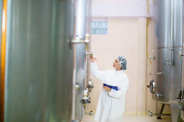 Close-up shot of milking machine in dairy factory without people