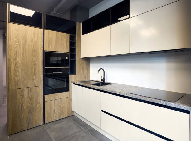istock Urban rustic loft style kitchen interior in wooden facade and stoneware countertop tabletop with built-in appliances as induction stove hob cooker sink microwave oven and oven fridge dishwasher 2148800637