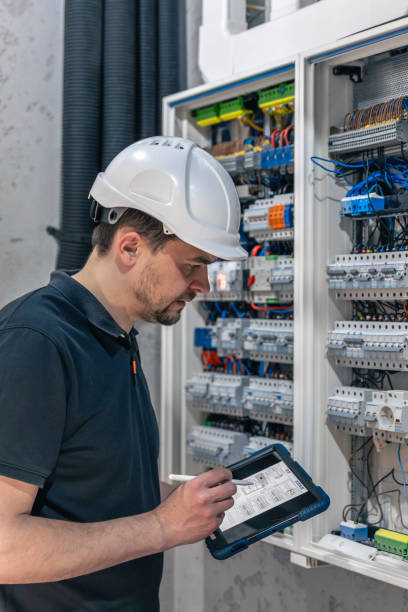 istock Man, an electrical technician working in a switchboard with fuses. 2148800797