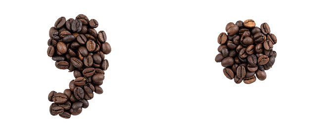 Point and comma marks made with coffee beans isolated on white background isolated. Caffeine typeface.