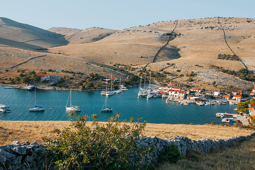 Scenic view of the blue lagoon village with many boats at sunset. Location place Kvarner Gulf, Croatia, Europe.