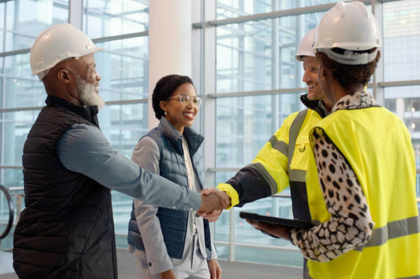 istock Construction workers and talking in office with tablet and handshake, management or meeting with colleagues. Group of people, indoors and discussion with team for renovation or architecture with deal 2148803561