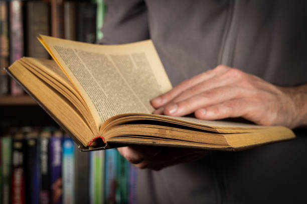 istock Men opening and reading a old book, close up 2148803715