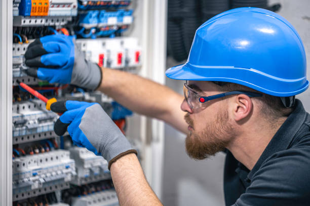istock A male electrician works in a switchboard with an electrical connecting cable. 2148804013