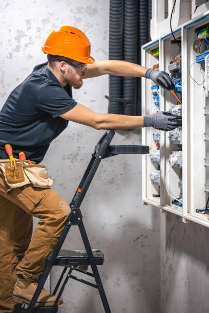 istock Male electrician working in a switchboard with fuses. 2148804017