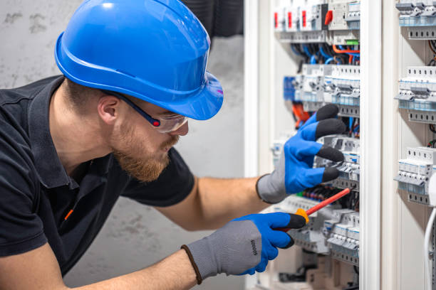 istock A male electrician works in a switchboard with an electrical connecting cable. 2148804022