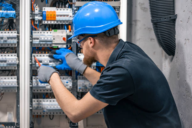 istock A male electrician works in a switchboard with an electrical connecting cable. 2148804257