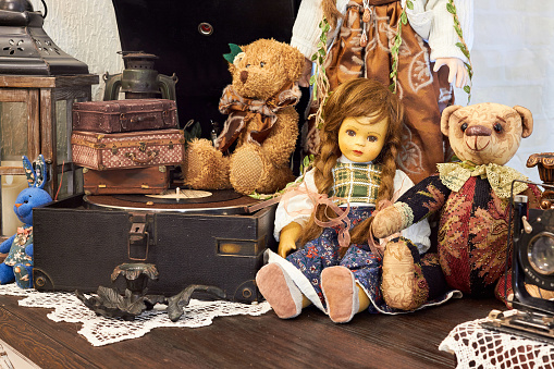 Vintage background with collection of antique childhood treasures - dolls and toys