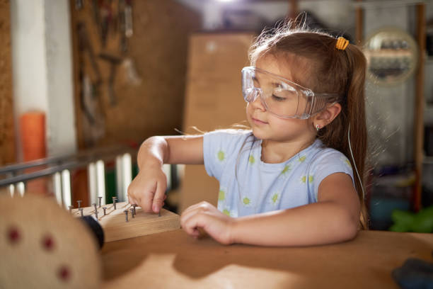 Beautiful girl ready for some DIY Beautiful girl reparing some old furniture in garage. girl with a hammer stock pictures, royalty-free photos & images