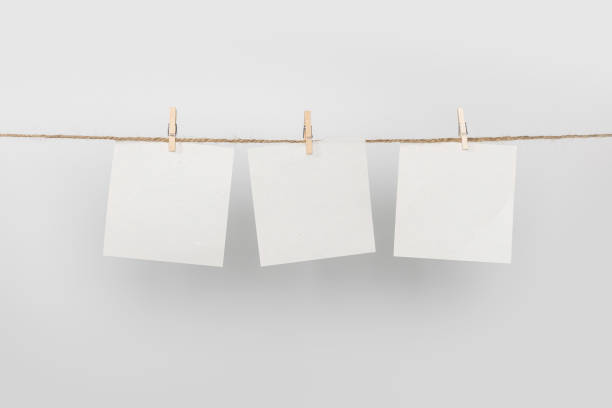 istock 3 Note paper cards hanging with wooden clip or clothespin on rope string peg isolated on white background 2148805459