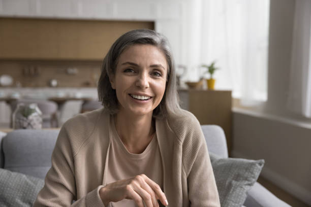 istock Happy mature woman spend time at home looking at camera 2148805645