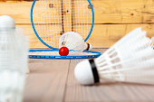 Badminton equipment. Rackets and shuttlecock on wooden table