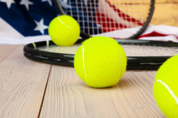 Tennis equipment on wooden surface close up