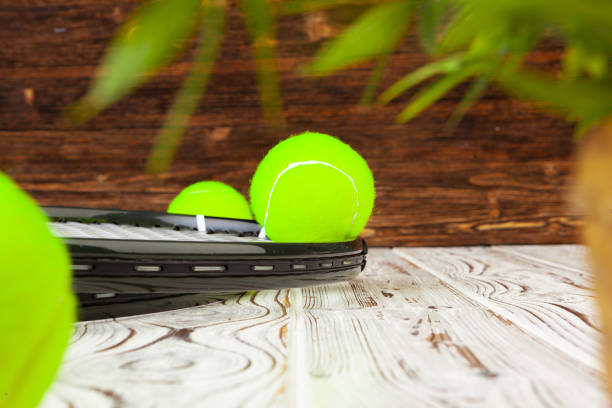 Tennis equipment on wooden surface close up