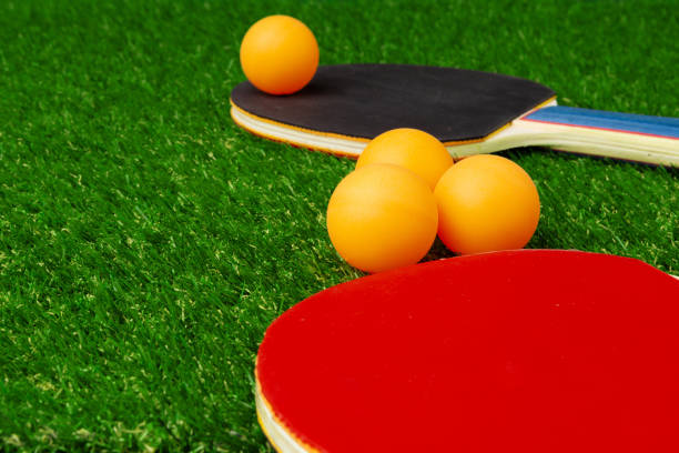istock Ping pong rackets and ball on grass 2148806215