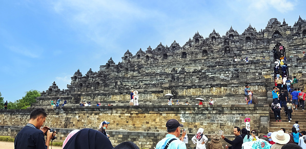 The scenery image of tourists visited the Borobudur Temple in Magelang, Central Java, Indonesia.