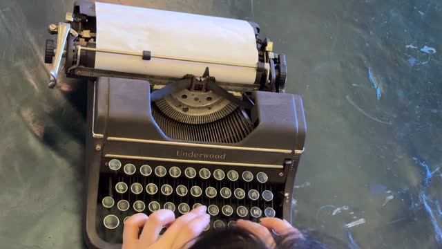 Pressing the keys of an old typewriter machine