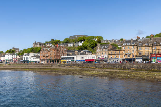 Oban - United Kingdom. May 21, 2023: Oban vibrant Queen Park Place basks in sunshine, with its historic Victorian architecture lining the peaceful seafront