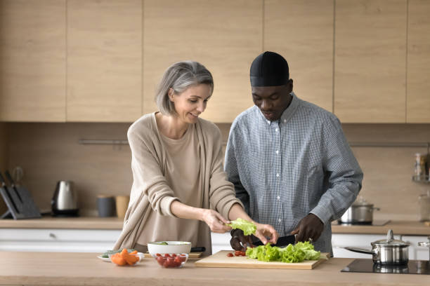 istock Happy multiethnic couple prepare vegetable salad together 2148808343