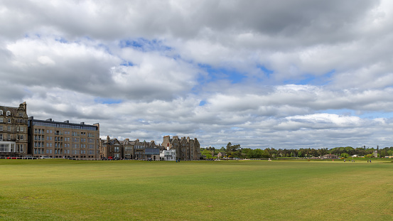 St Andrews - United Kingdom. May 27, 2023: Captured at The Old Course in St Andrews, this image showcases the iconic golfing landscape against a backdrop of traditional architecture