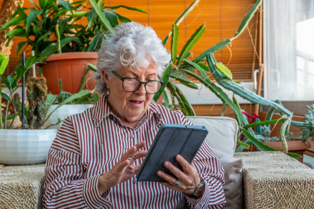 istock Surprised elderly woman looking at device screen 2148808494