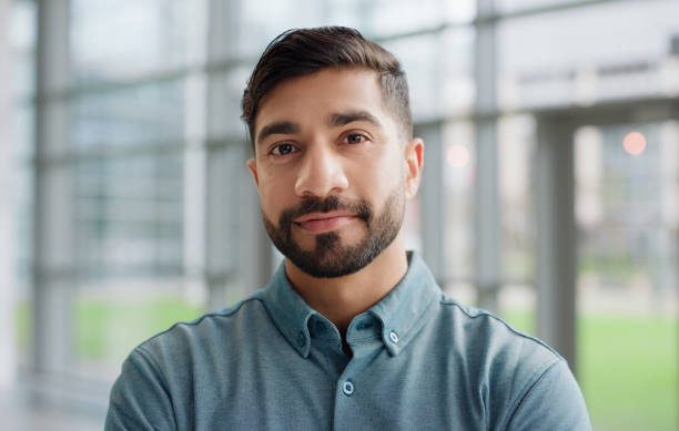 istock Portrait, closeup and man with confidence in office, workspace or professional space with happiness for corporate career. Male person, intern or employee for banking firm, investment or trade company 2148808570