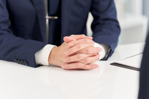 Hands of a businessman having an interview