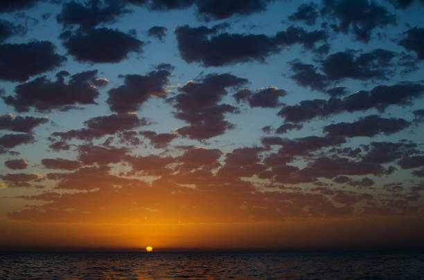 Orange sunset sun on sky with clouds