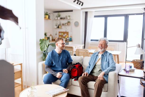 istock Caregiver talking with a happy senior man 2148809165
