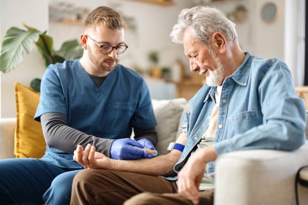 istock Male nurse draws blood from a senior patient 2148809180