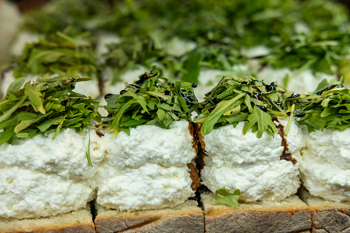 Detail of an appetizing bite of cottage cheese with lettuce and Modena vinegar.